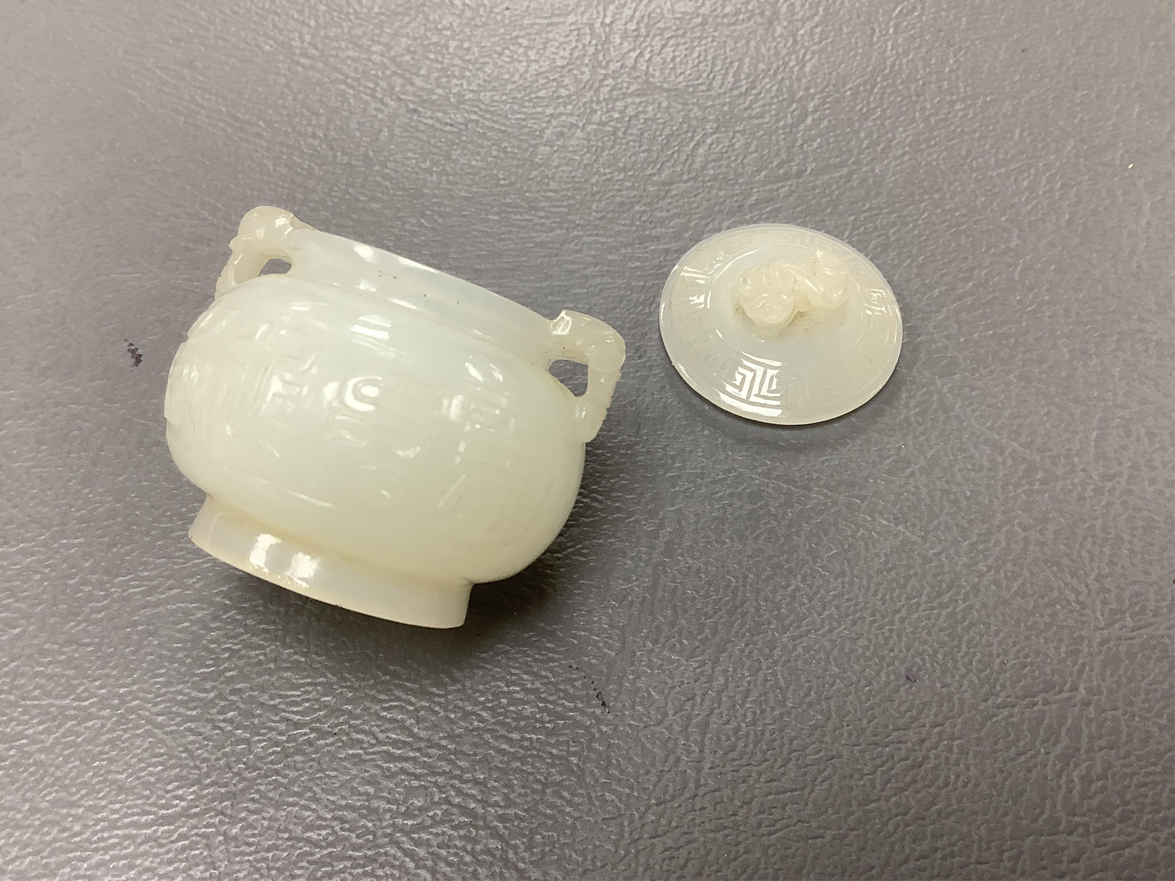 A Chinese jade figure of a Mandarin duck and a miniature pot and cover, three jadeite carvings and a bowenite dragon, 16.5cm